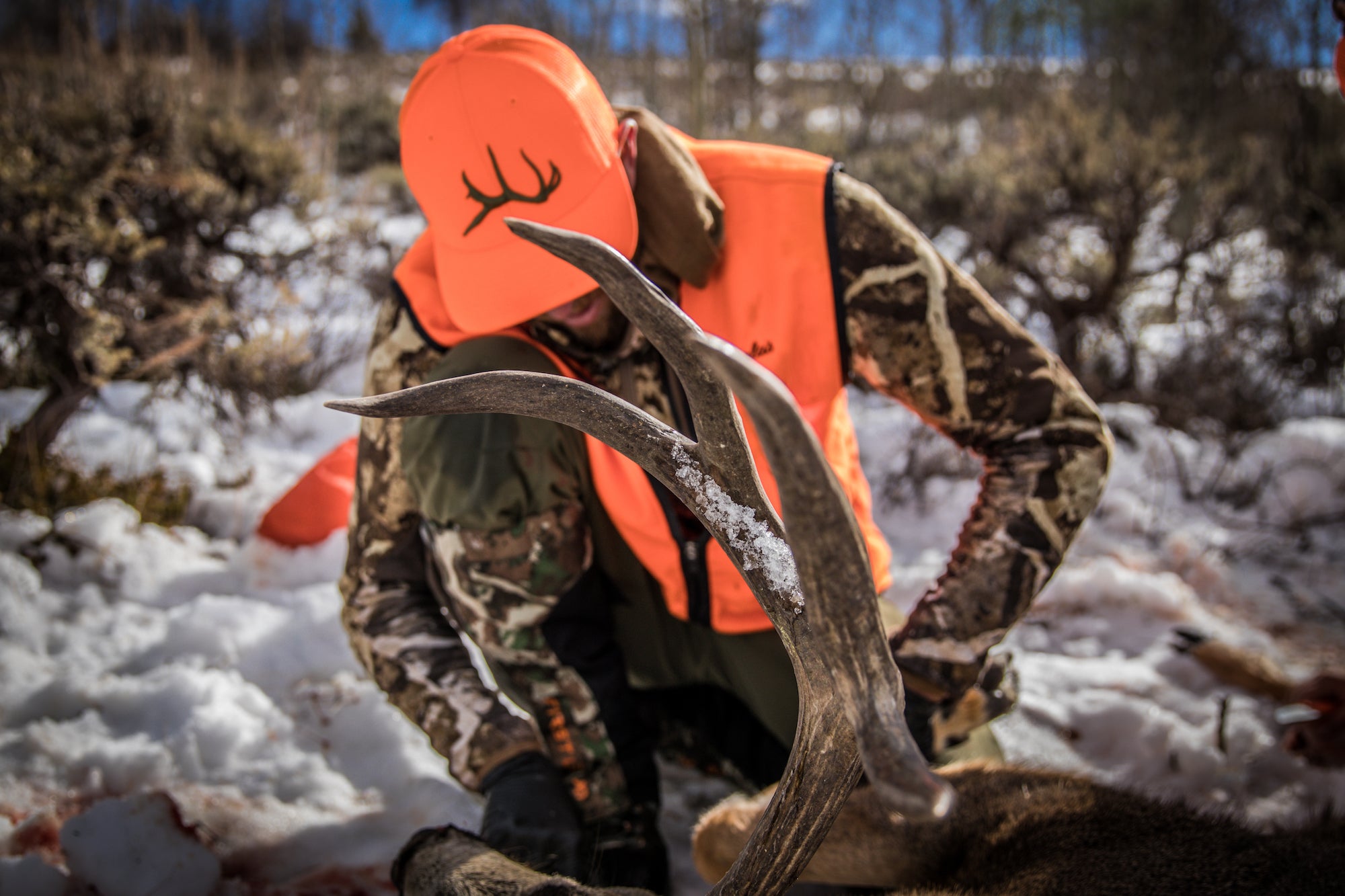 Man wearing blaze orange odd six hat