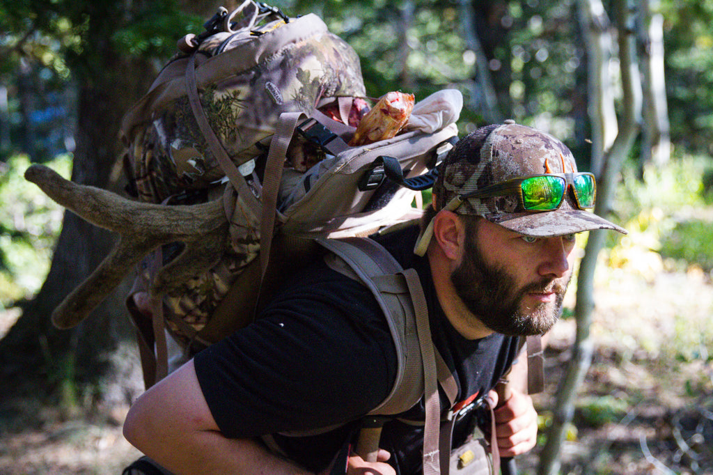 Man with first lite cipher cap in wood hunting