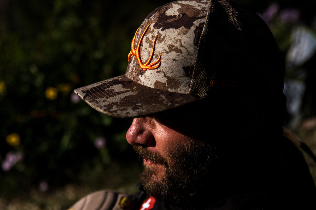 Man with first lite cipher cap in wood hunting